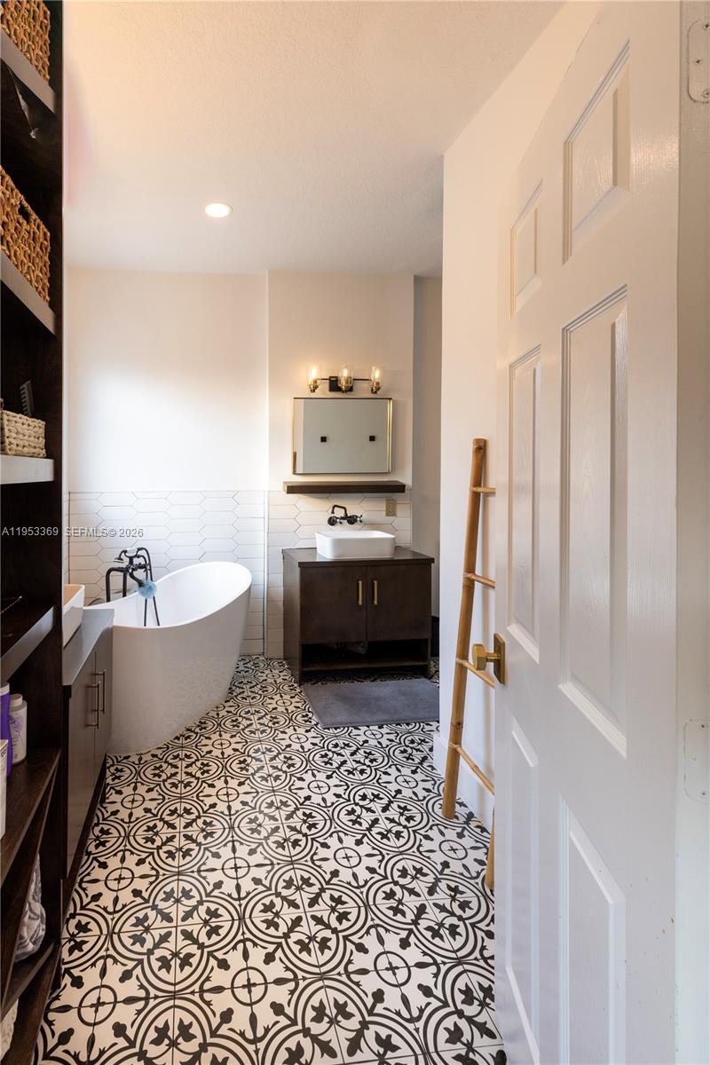 13276 Southwest 128th Street Miami, FL 33186 - Photo 14 of 43 a bathroom with a bathtub sink and toilet