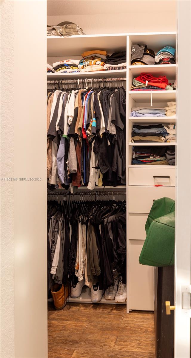13276 Southwest 128th Street Miami, FL 33186 - Photo 22 of 43 a view of walk in closet with clothes and shoes