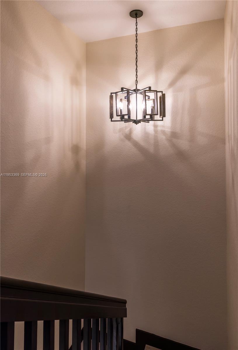 13276 Southwest 128th Street Miami, FL 33186 - Photo 24 of 43 a view of a hallway with a chandelier
