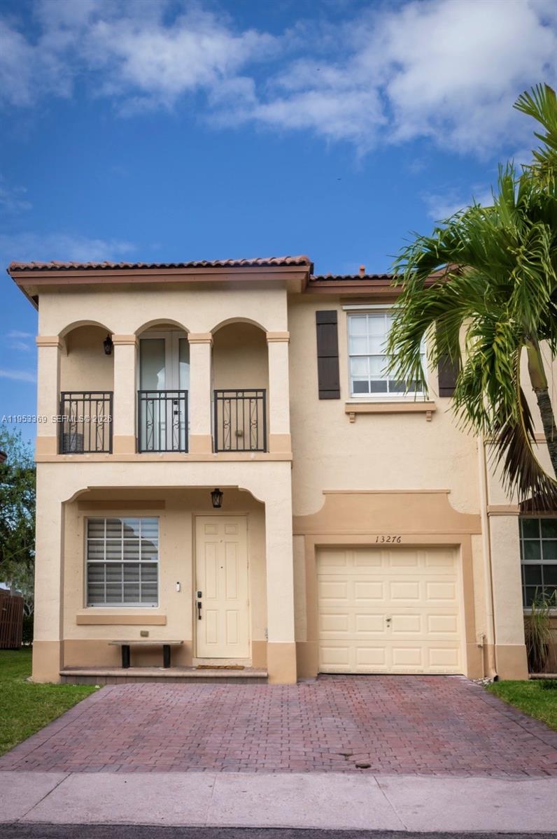 13276 Southwest 128th Street Miami, FL 33186 - Photo 31 of 43 a front view of a house with a yard and garage