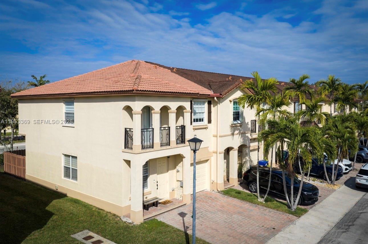 13276 Southwest 128th Street Miami, FL 33186 - Photo 33 of 43 a front view of a house with a yard