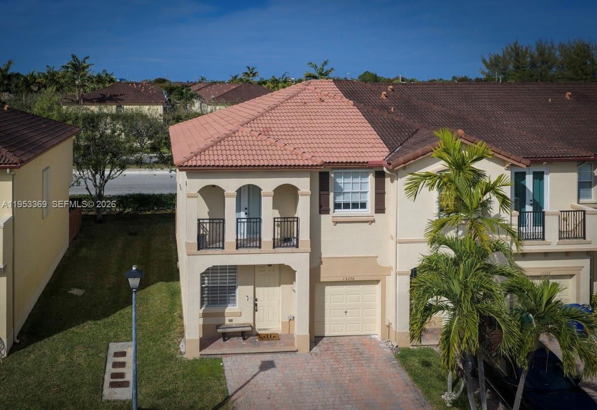 13276 Southwest 128th Street Miami, FL 33186 - Photo 40 of 43 a front view of a house with garden