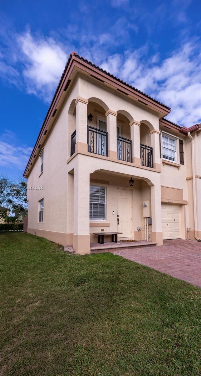 13276 Southwest 128th Street Miami, FL 33186 - Photo 41 of 43 a front view of a house with a yard