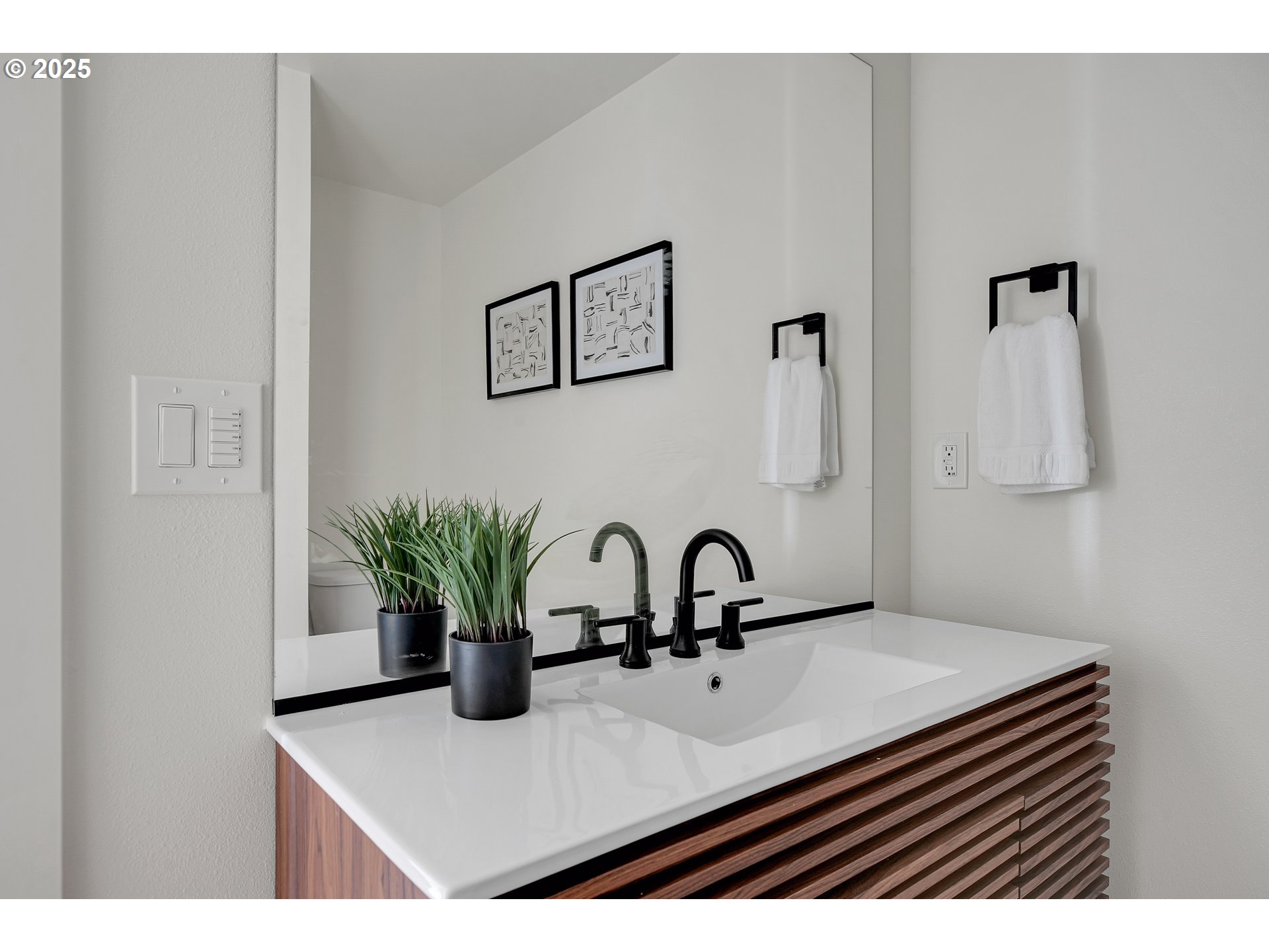 14834 Northeast Couch Street, Unit 6 Portland, OR 97230 - Photo 27 of 42 a bathroom with a sink a mirror and a potted plant