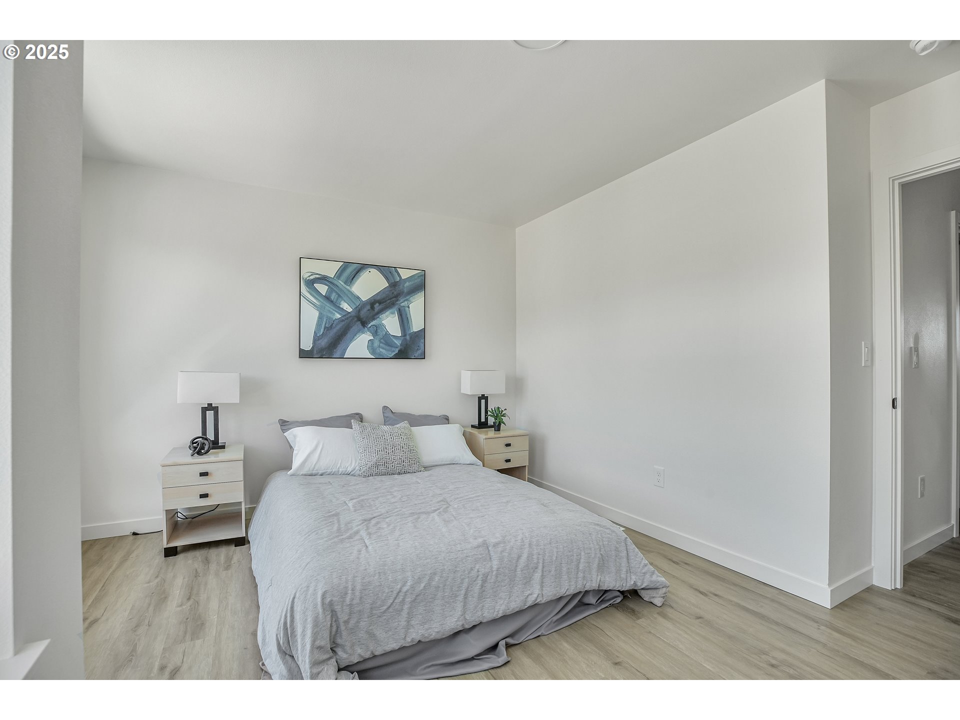 14834 Northeast Couch Street, Unit 6 Portland, OR 97230 - Photo 29 of 42 a bedroom with a bed and a painting on the wall