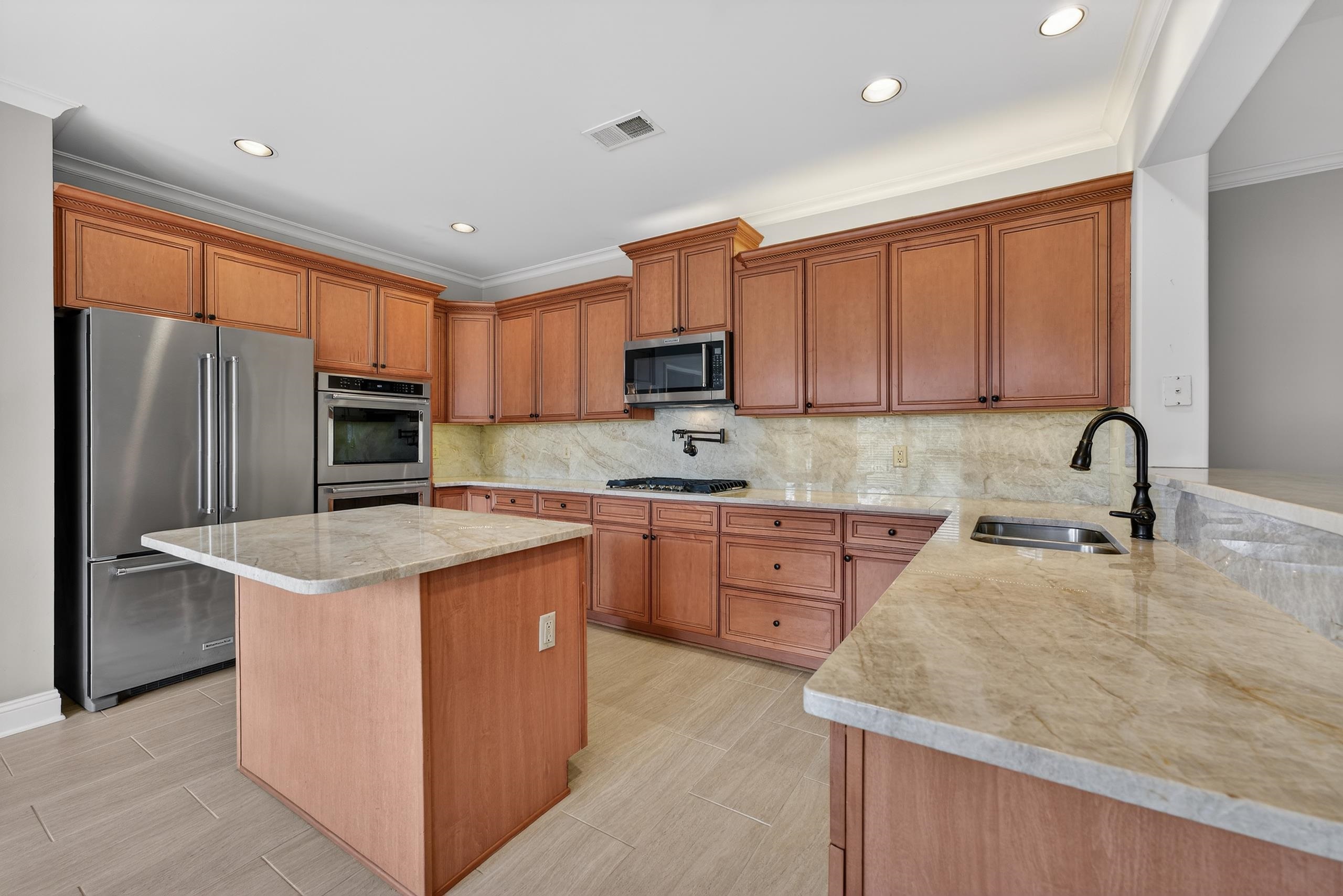1944 Laurel Lane Collierville, TN 38139 - Photo 13 of 30 a kitchen with stainless steel appliances granite countertop a sink stove refrigerator and cabinets
