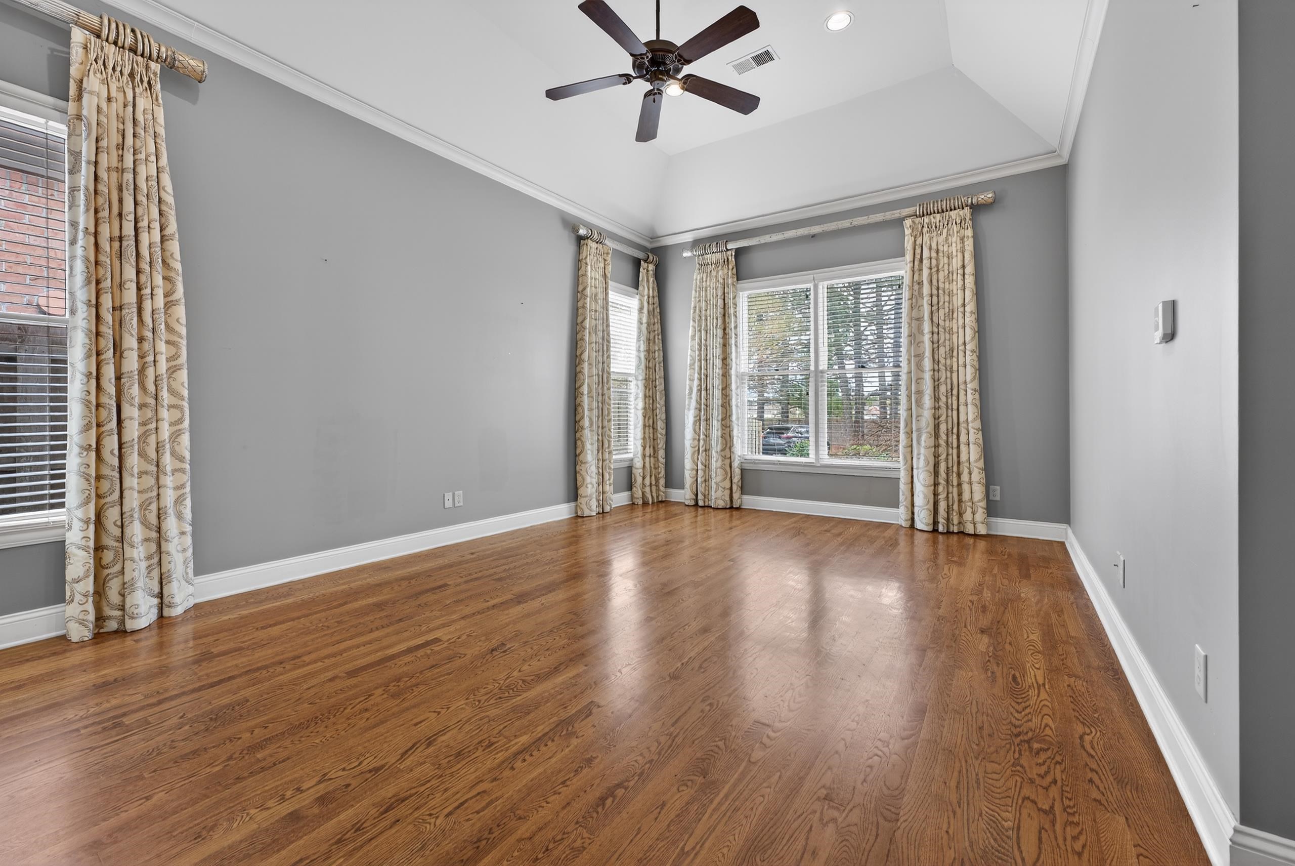 1944 Laurel Lane Collierville, TN 38139 - Photo 15 of 30 a view of a livingroom with wooden floor and a ceiling fan