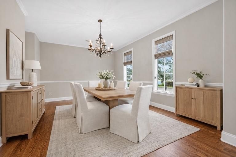 1944 Laurel Lane Collierville, TN 38139 - Photo 2 of 30 a dining room with wooden floor a chandelier a wooden table and chairs
