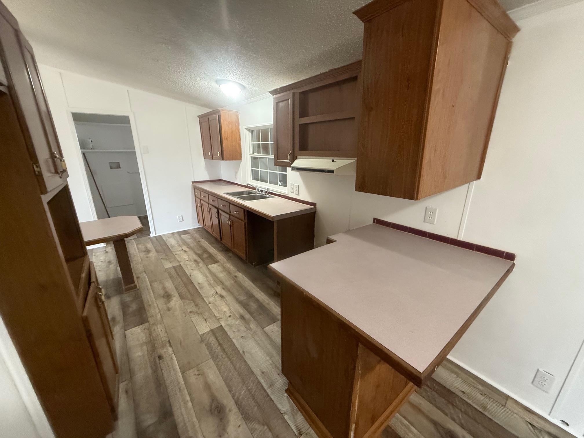 1688 Hardin Graveyard Road Adamsville, TN 38310 - Photo 12 of 40 a kitchen with a stove and a refrigerator
