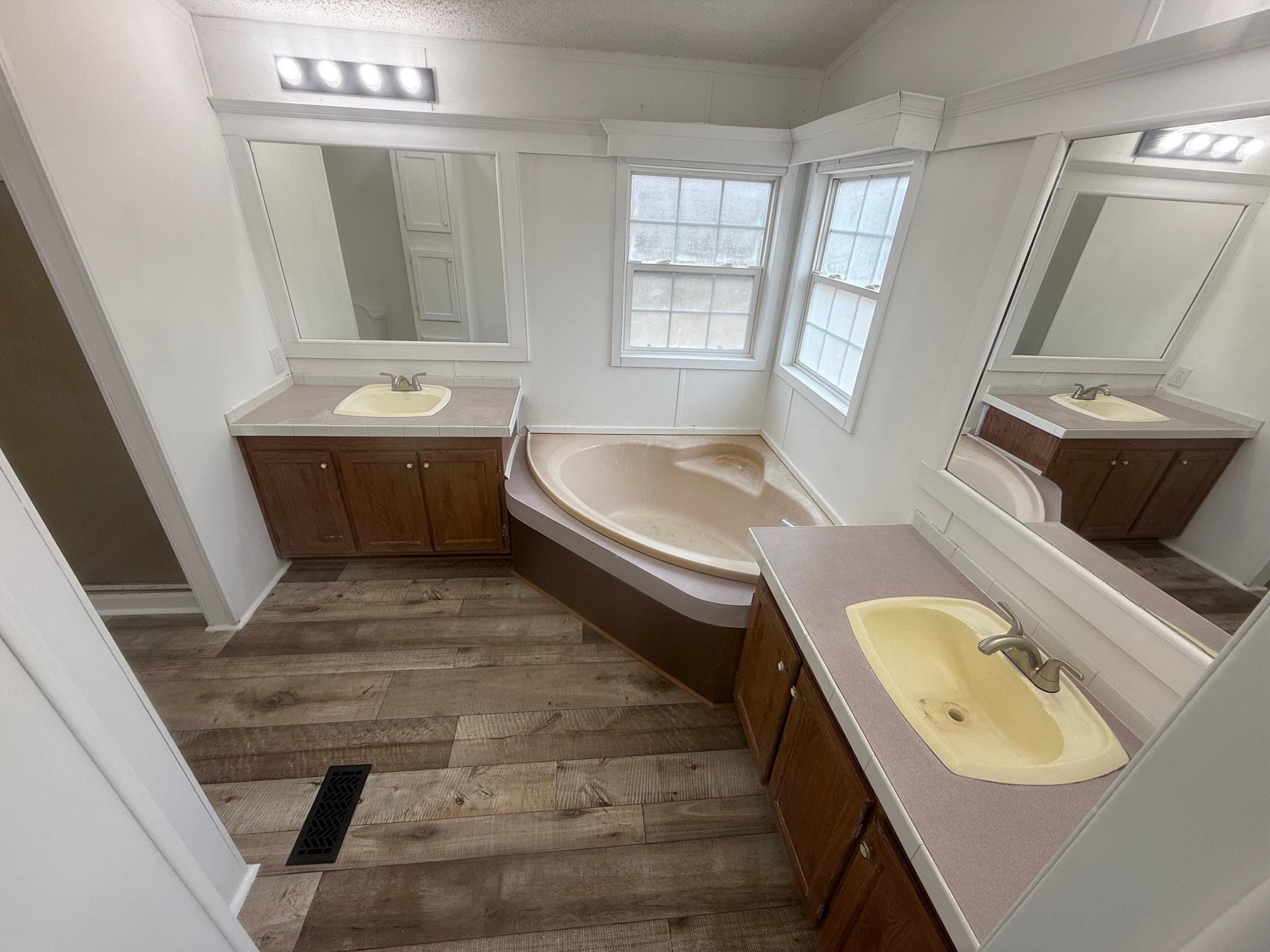 1688 Hardin Graveyard Road Adamsville, TN 38310 - Photo 15 of 40 a bathroom with a tub sink toilet and mirror