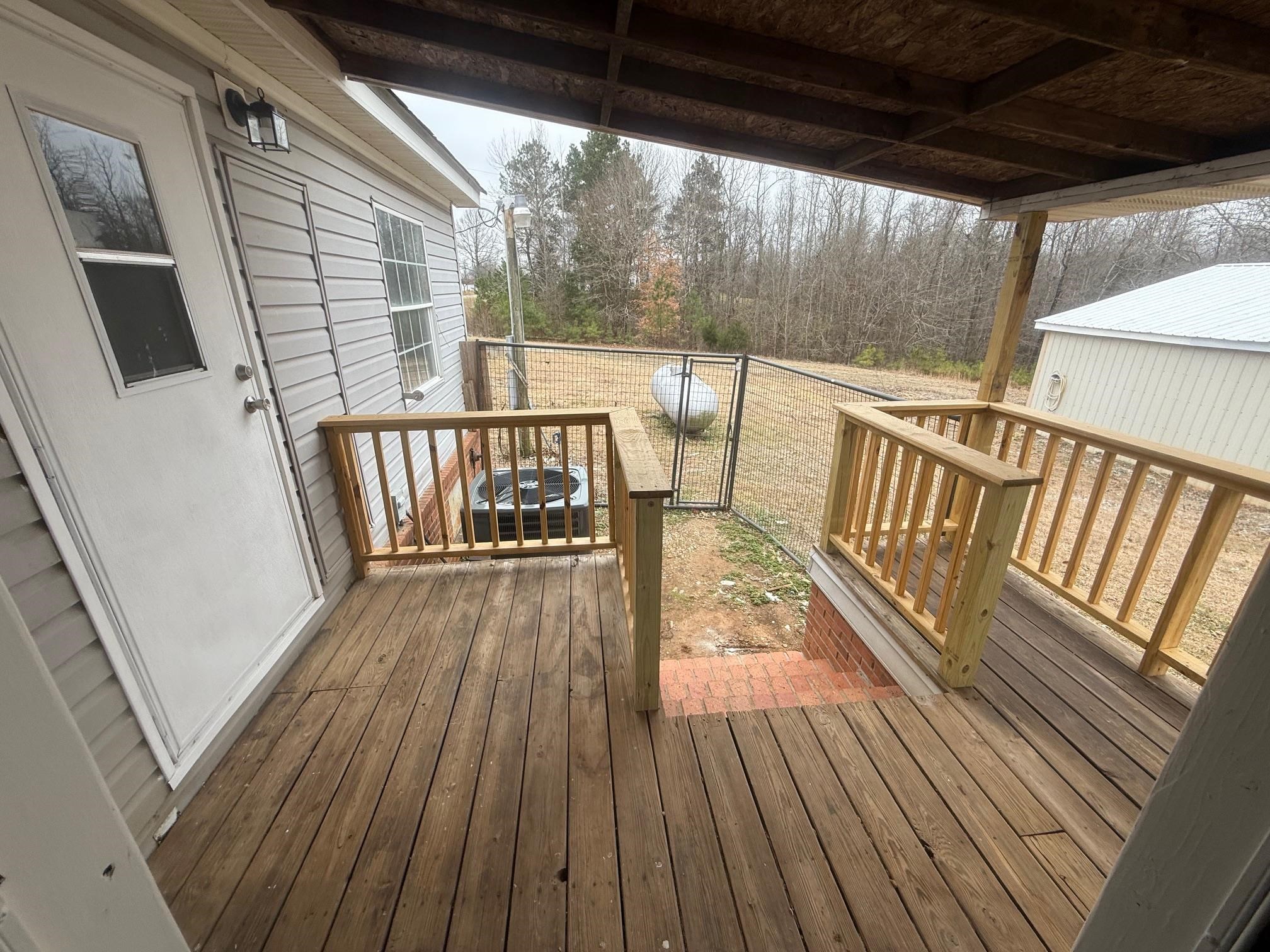 1688 Hardin Graveyard Road Adamsville, TN 38310 - Photo 22 of 40 a view of deck with wooden floor and outdoor seating
