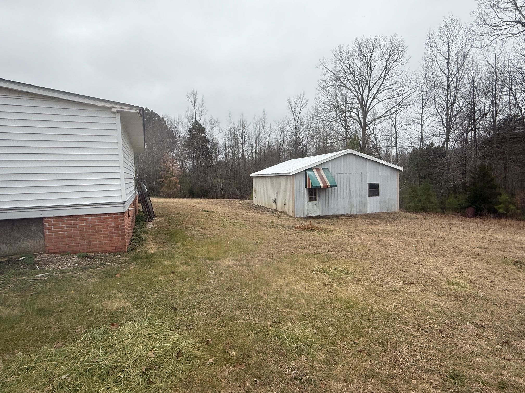 1688 Hardin Graveyard Road Adamsville, TN 38310 - Photo 39 of 40 a backyard of a house with large trees