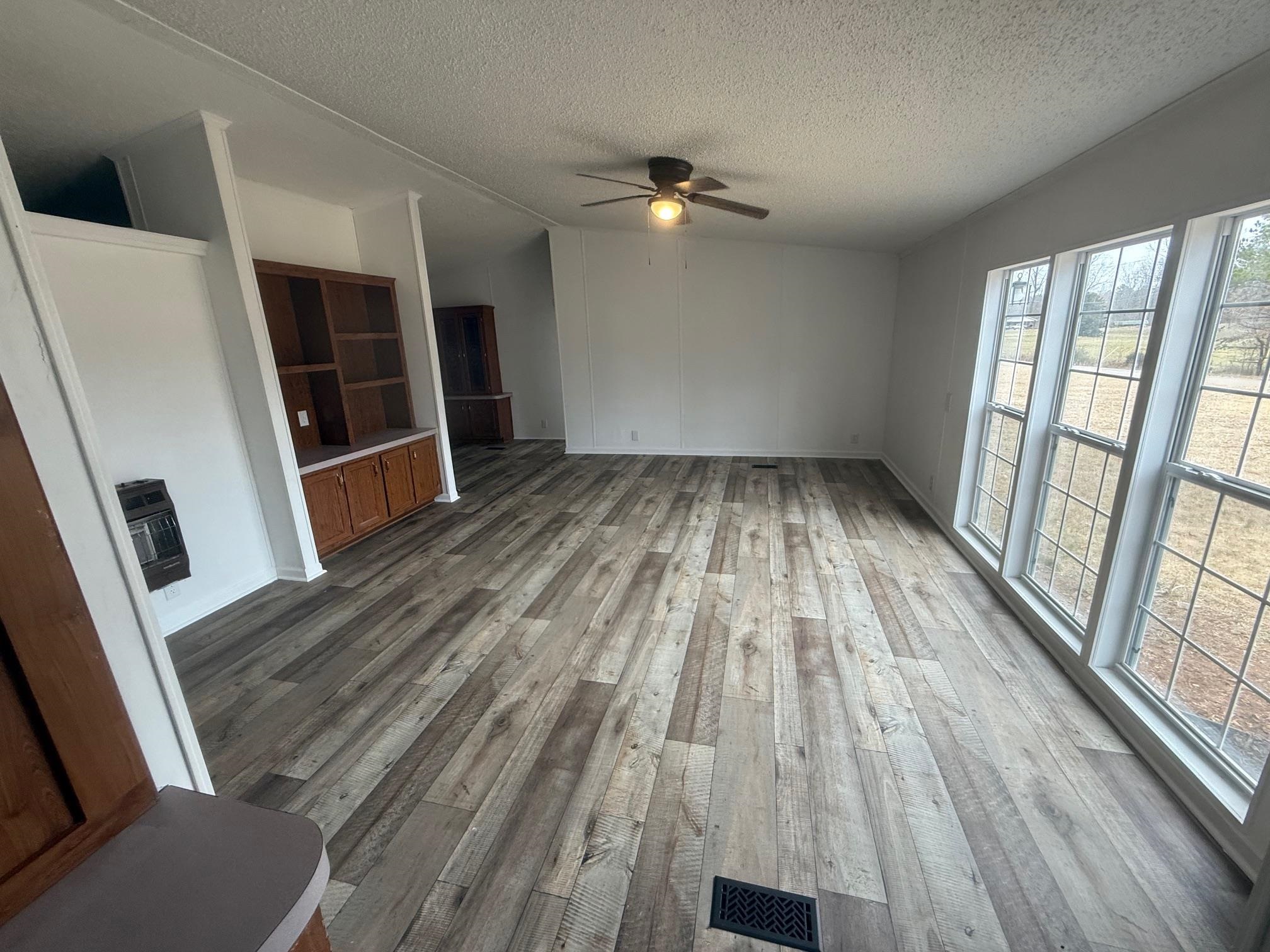 1688 Hardin Graveyard Road Adamsville, TN 38310 - Photo 6 of 40 a view of wooden floor in a room