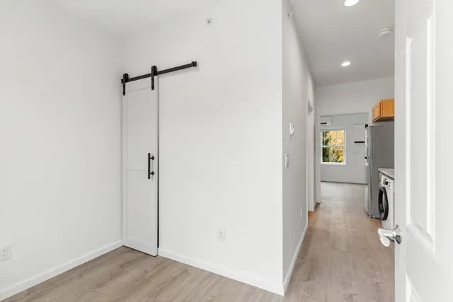 a view of a room with wooden floor