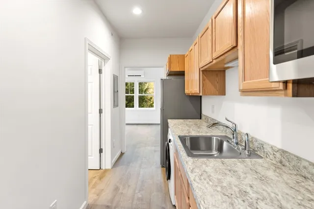 a kitchen with stainless steel appliances granite countertop a sink a stove and a microwave oven