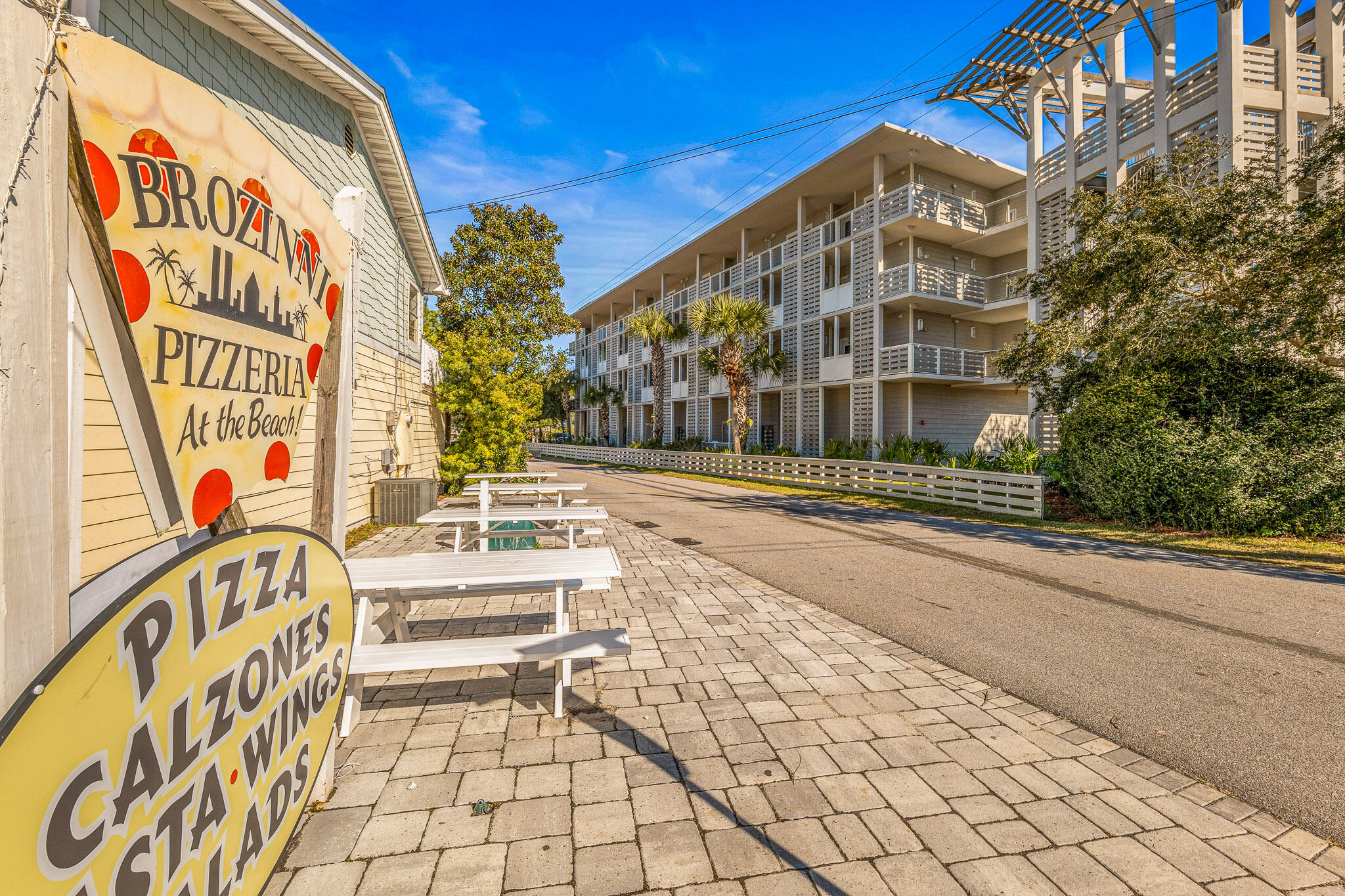 43 Cassine Way, Unit 206 Santa Rosa Beach, FL 32459 - Photo 12 of 32 a building exterior with stairs and a bench