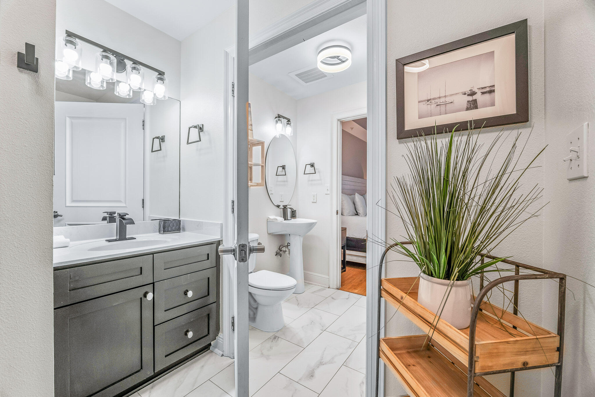 43 Cassine Way, Unit 206 Santa Rosa Beach, FL 32459 - Photo 22 of 32 a bathroom with a granite countertop sink a toilet and with mirror