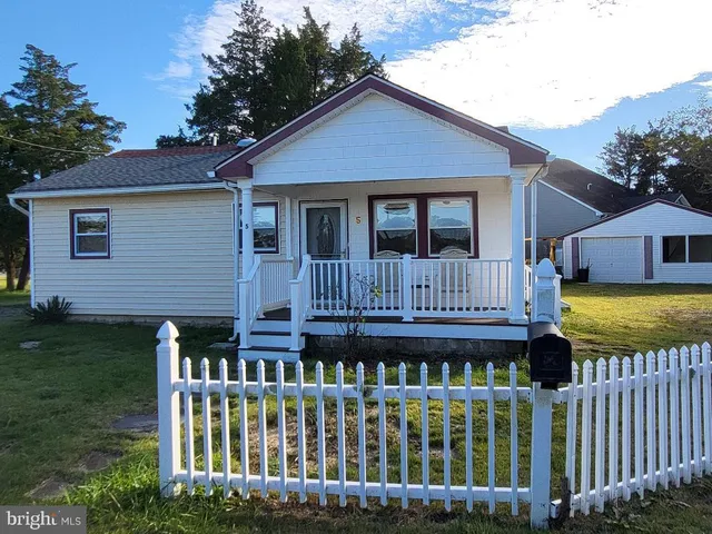 a front view of a house with wooden fence