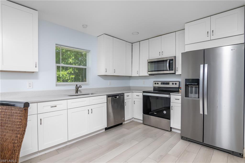 2826 W Road Fort Myers, FL 33905 - Photo 8 of 17 a kitchen with cabinets stainless steel appliances and a window