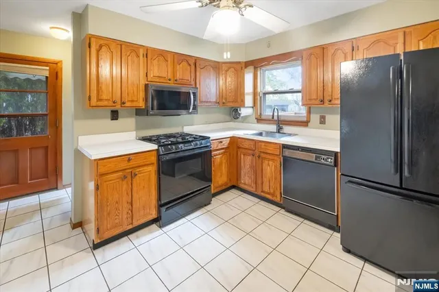 a kitchen with stainless steel appliances granite countertop a stove sink and refrigerator