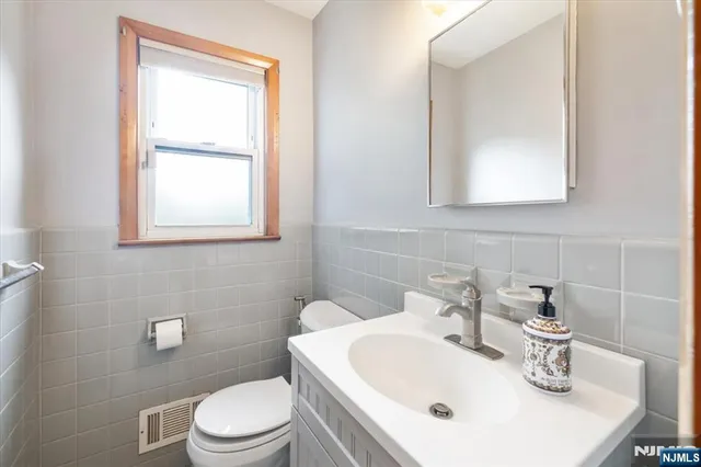 a bathroom with a sink a toilet and mirror