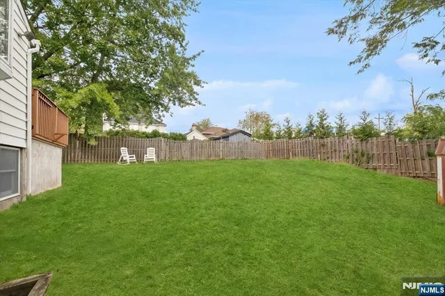 a view of yard with grass and trees