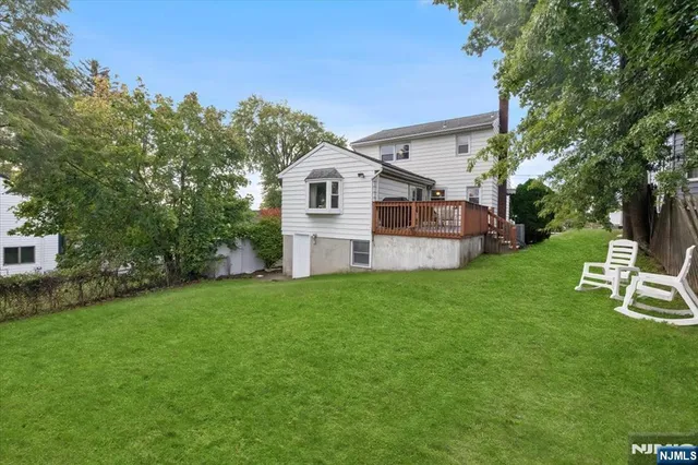 a view of a house with a yard and sitting area