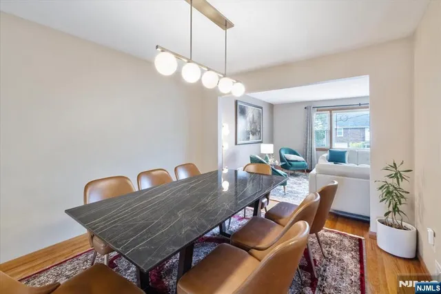a living room with furniture a chandelier and a rug