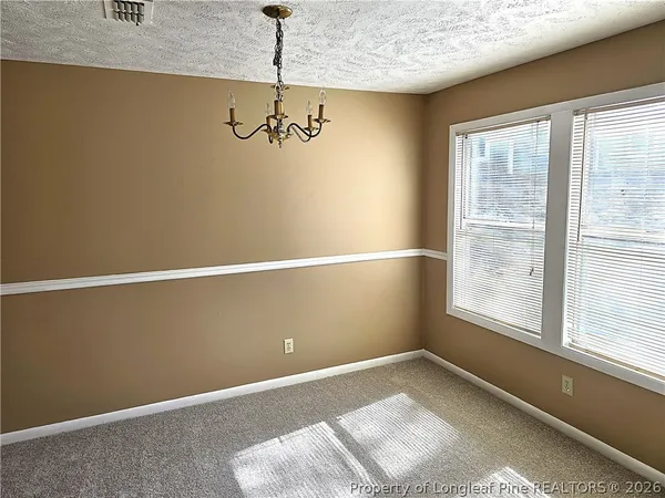 a view of a livingroom with furniture and a kitchen view