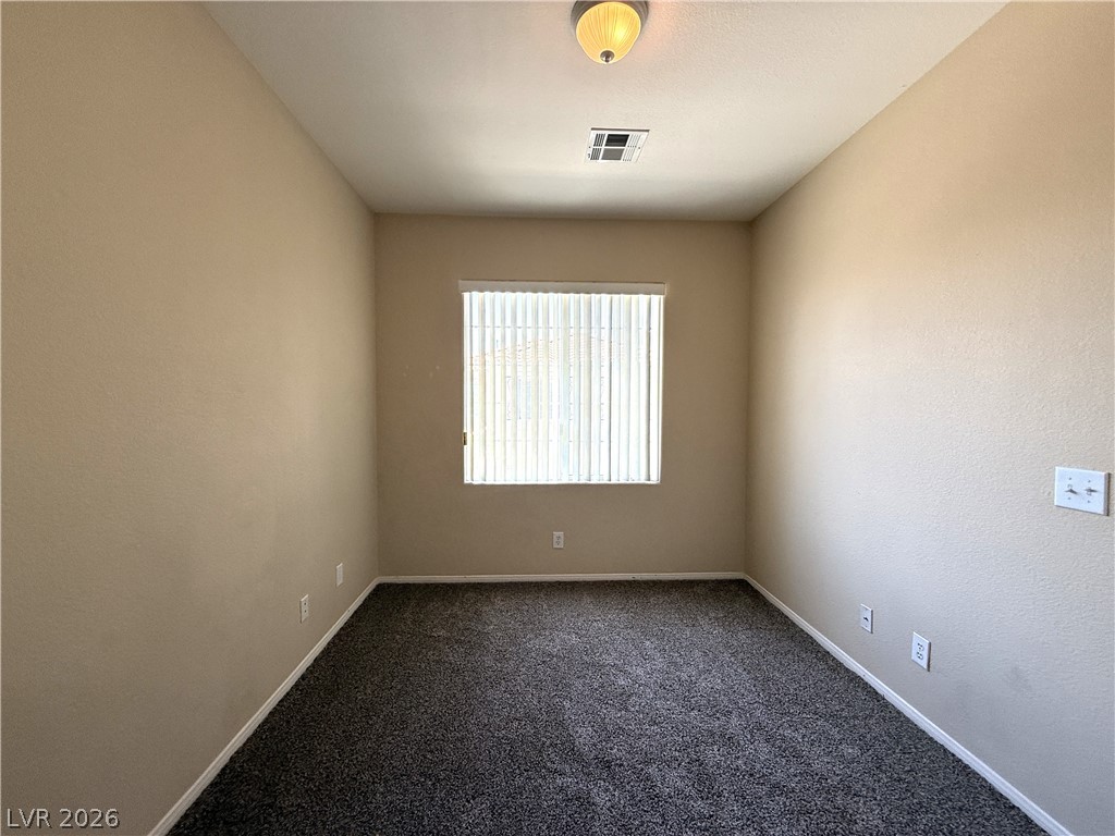 5942 Rampolla Drive Las Vegas, NV 89141 - Photo 22 of 27 An inviting room awaits personalization with its soft carpet and natural light filtering through the window.