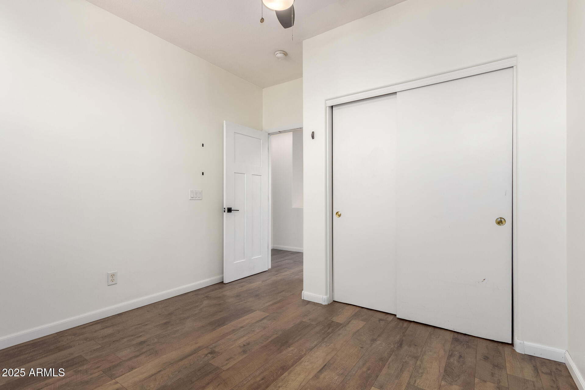 1886 East Don Carlos, Unit 147 Tempe, AZ 85281 - Photo 13 of 22 a view of an empty room with wooden floor