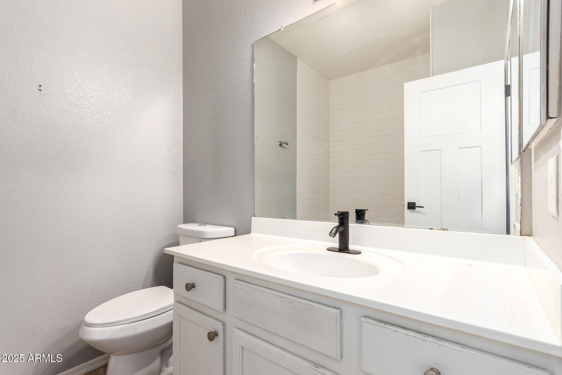 1886 East Don Carlos, Unit 147 Tempe, AZ 85281 - Photo 14 of 22 a bathroom with a sink toilet and mirror