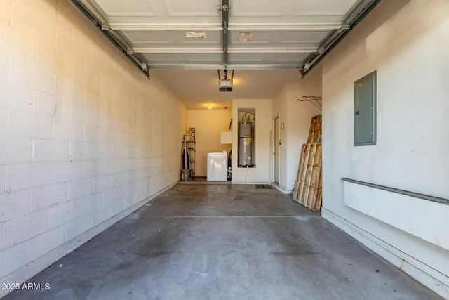 a view of a hallway with a white car parked in garage