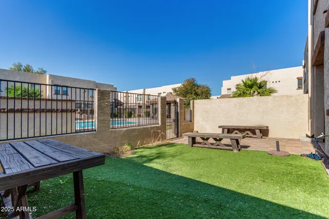 a view of a chair and table on the wooden deck