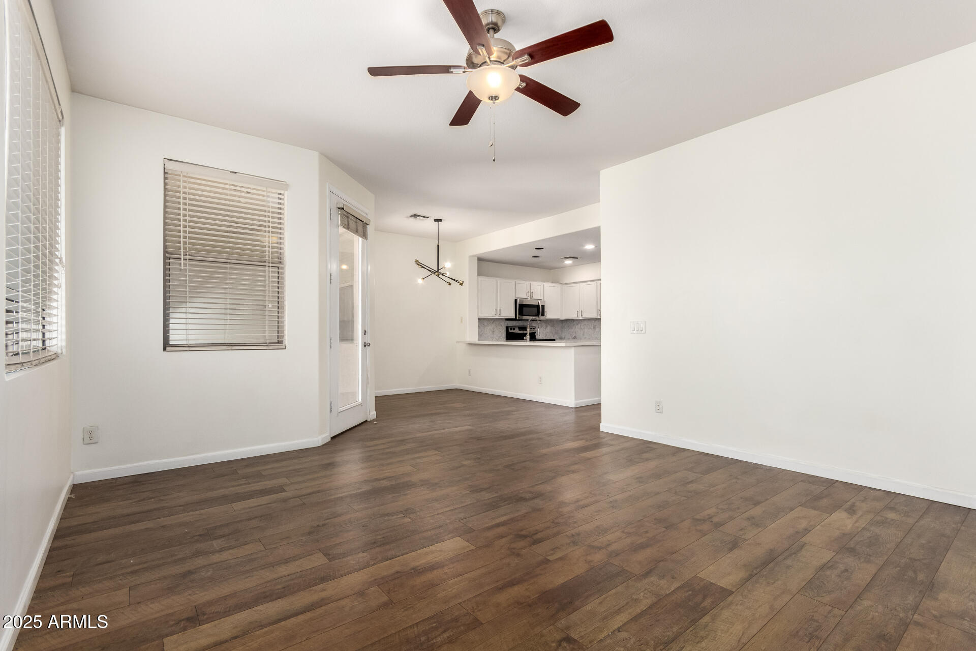 1886 East Don Carlos, Unit 147 Tempe, AZ 85281 - Photo 3 of 22 a view of a kitchen with wooden floor and a ceiling fan