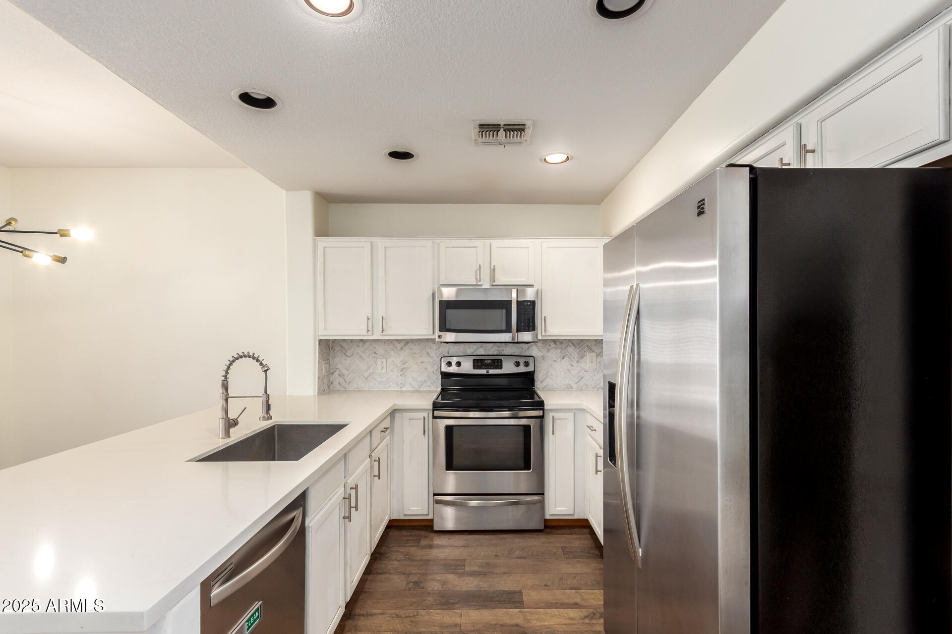 1886 East Don Carlos, Unit 147 Tempe, AZ 85281 - Photo 4 of 22 a kitchen with granite countertop a refrigerator and a sink
