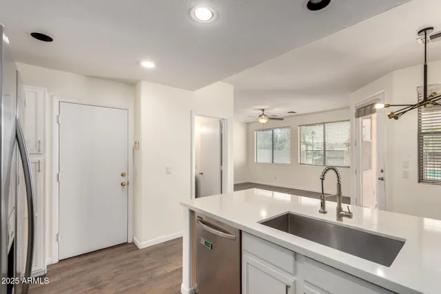 a view of a sink and mirror with wooden floor