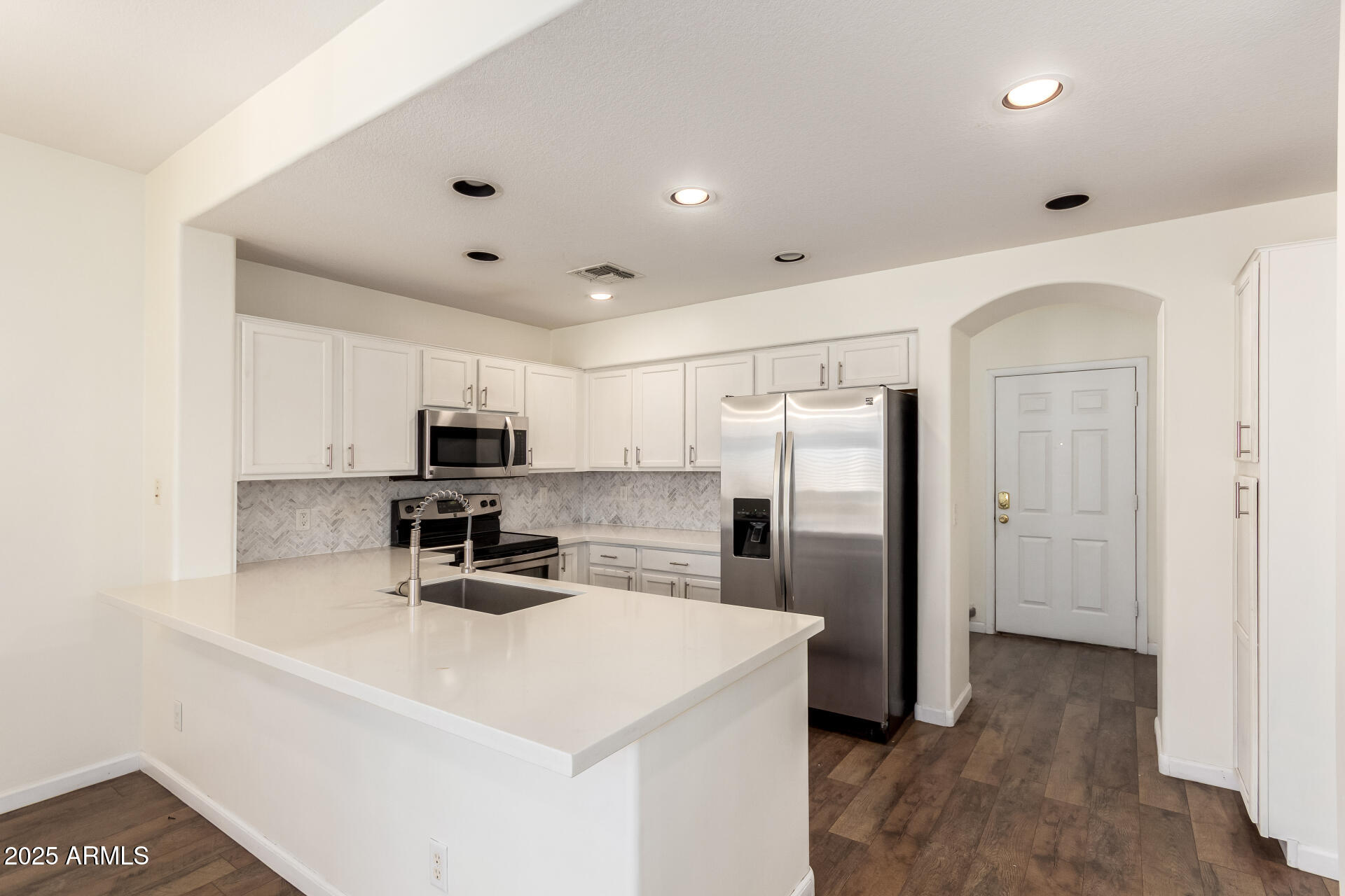 1886 East Don Carlos, Unit 147 Tempe, AZ 85281 - Photo 6 of 22 a kitchen with stainless steel appliances a refrigerator sink and microwave