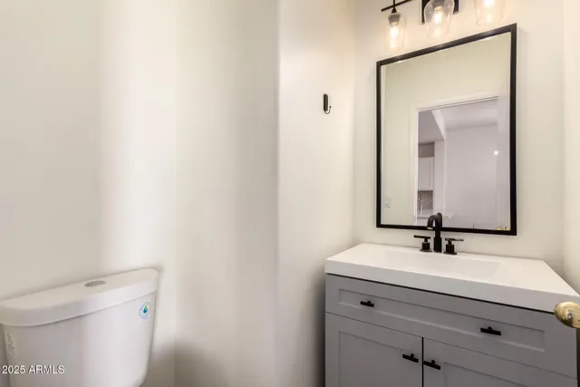 a bathroom with a sink a toilet and mirror