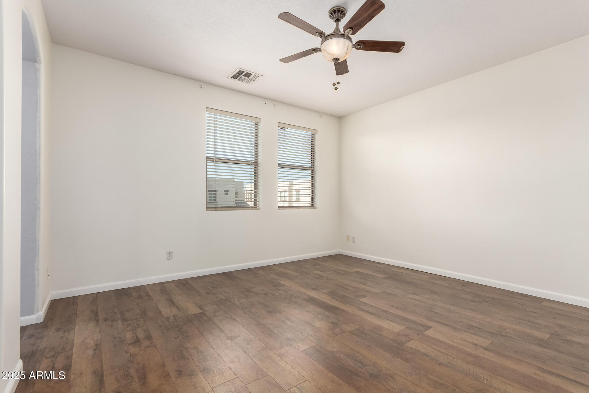 1886 East Don Carlos, Unit 147 Tempe, AZ 85281 - Photo 8 of 22 an empty room with wooden floor ceiling fan and windows