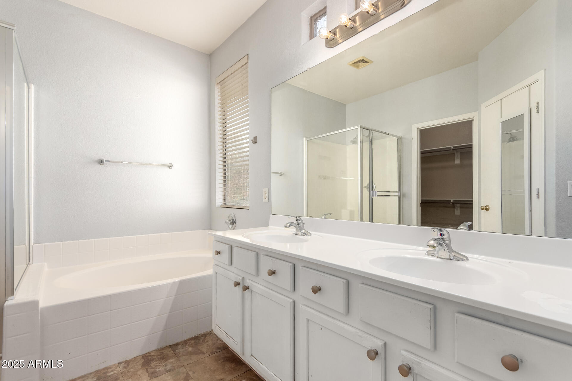 1886 East Don Carlos, Unit 147 Tempe, AZ 85281 - Photo 9 of 22 a bathroom with a tub a sink double vanity and a mirror