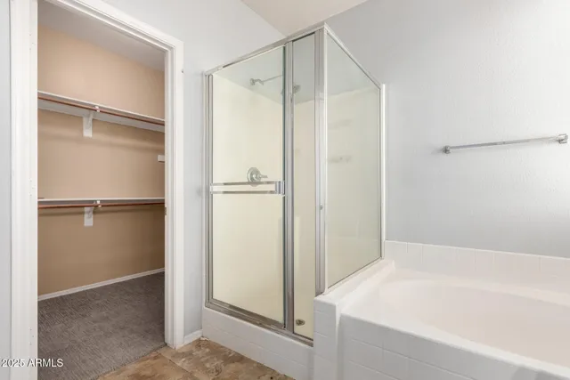a bathroom with a bathtub and a shower