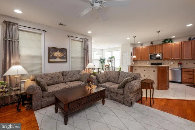 a living room with furniture and kitchen view