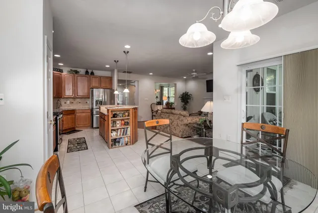 a dining room with furniture a potted plant and a painting
