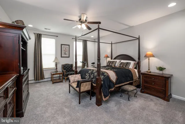 a bedroom with bed and a chandelier