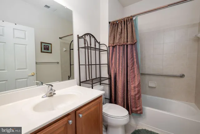 a living room with furniture and large windows