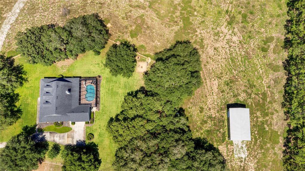 9045 Lake Hatchineha Road Kissimmee, FL 34759 - Photo 7 of 47 an aerial view of a house with a yard