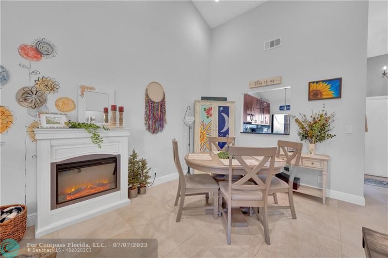 10999 Water Oak Manor Boca Raton, FL 33498 - Photo 17 of 49 a dining room with furniture and a fireplace
