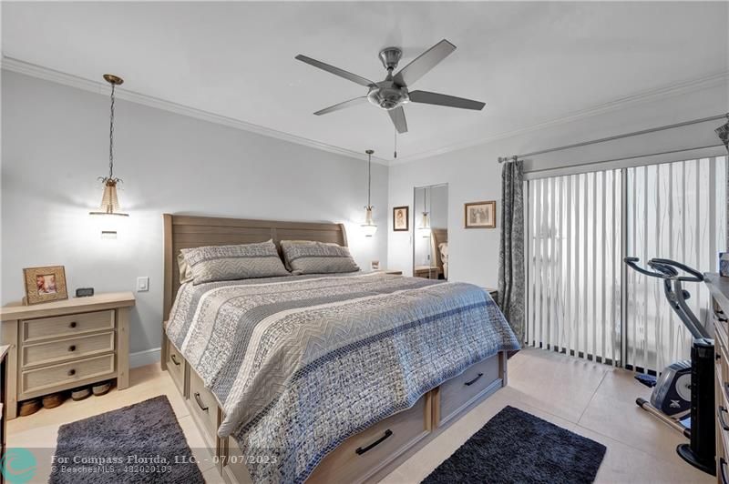 10999 Water Oak Manor Boca Raton, FL 33498 - Photo 29 of 49 a bedroom with a bed and a chandelier