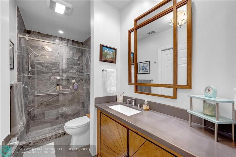 10999 Water Oak Manor Boca Raton, FL 33498 - Photo 31 of 49 a bathroom with a granite countertop sink toilet and shower